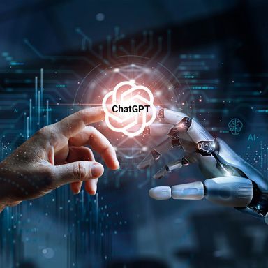 Fingerspitzen von einer KI / AI und Mensch berühren sich und zeigt das ChatGPT-Logo.