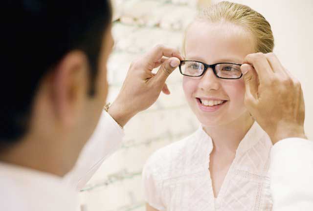 Dispensing optician fitting glasses Dispensing optician fitting glasses