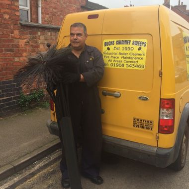 Ray the Chimney Sweep with his brushes and distinctive yellow van