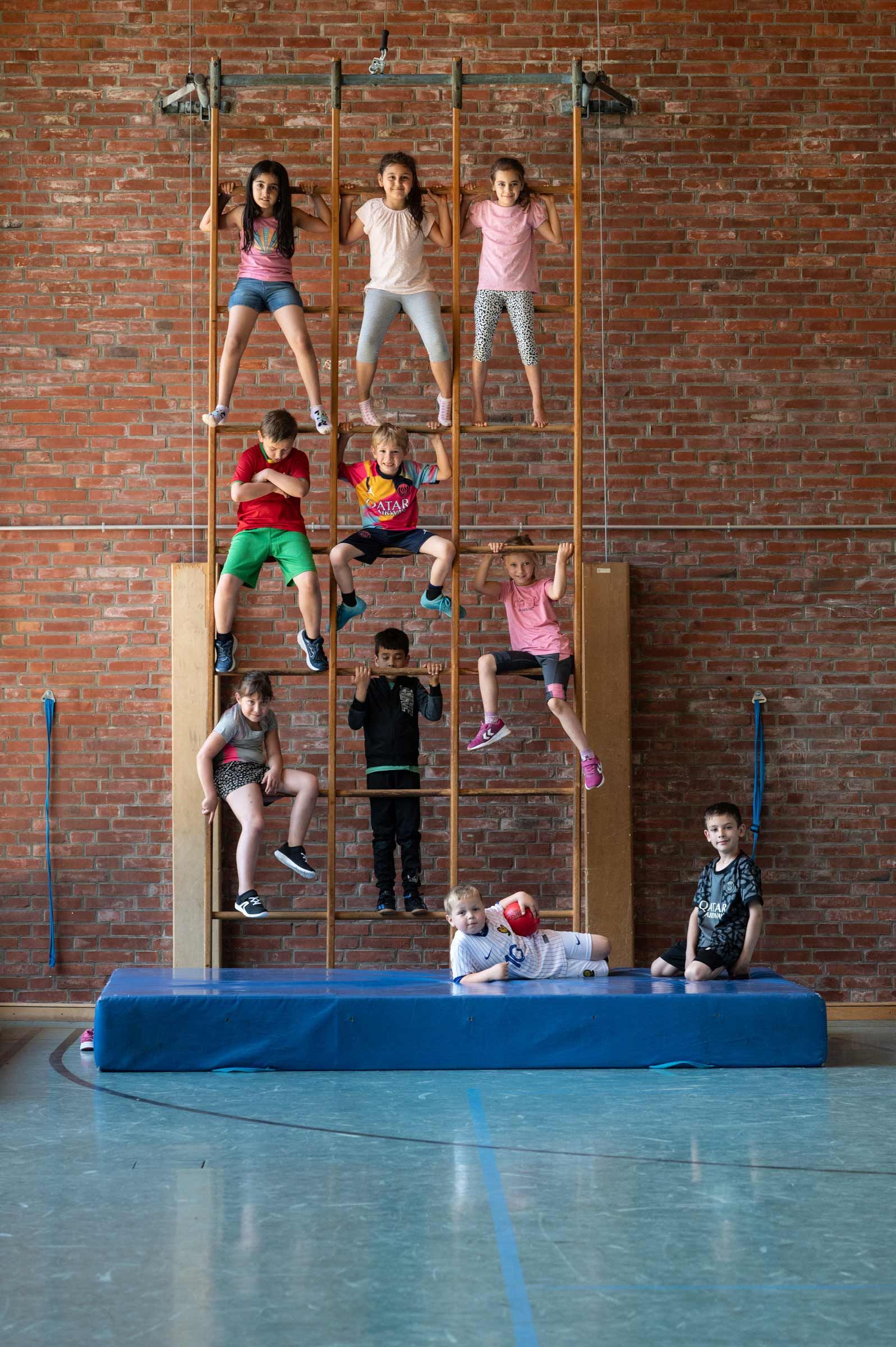 Kinder an einer Sprossenwand. Schulfotografie und Schulreportage-Fotografie aus Hamburg von Kay Winter / WINTERPOL