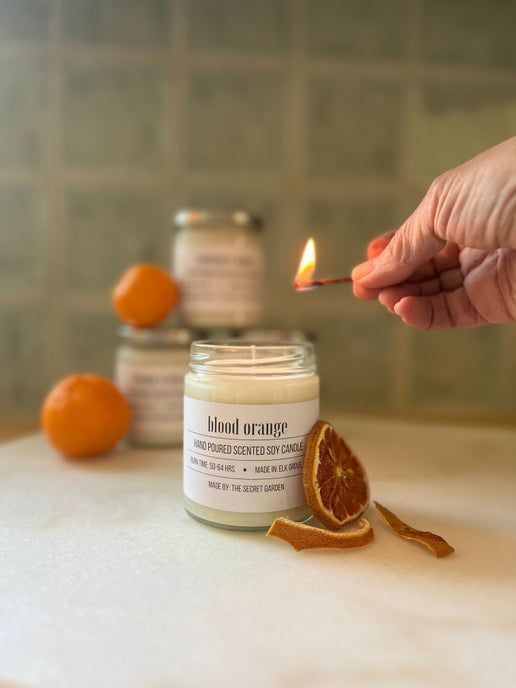 hand with match lighting candle