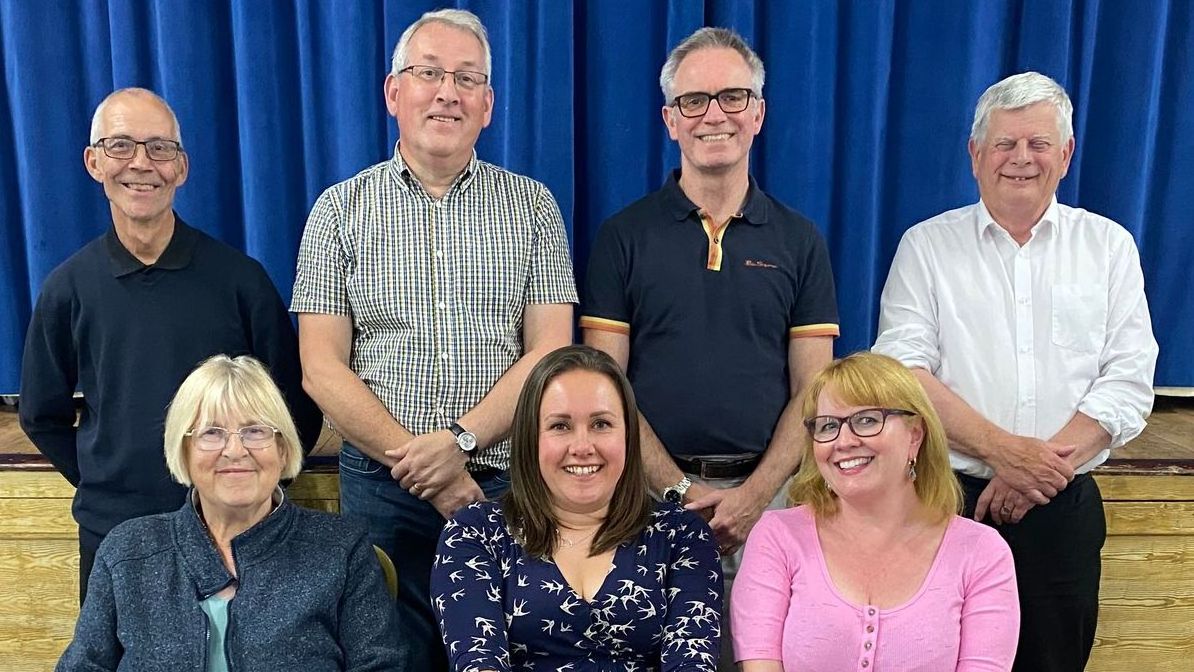 Photo of Parish Councillors standing amongst ceramic poppies