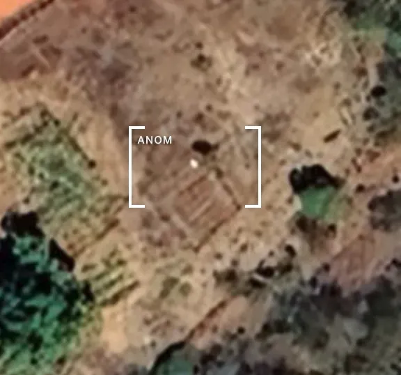 A small white dot over farmland.