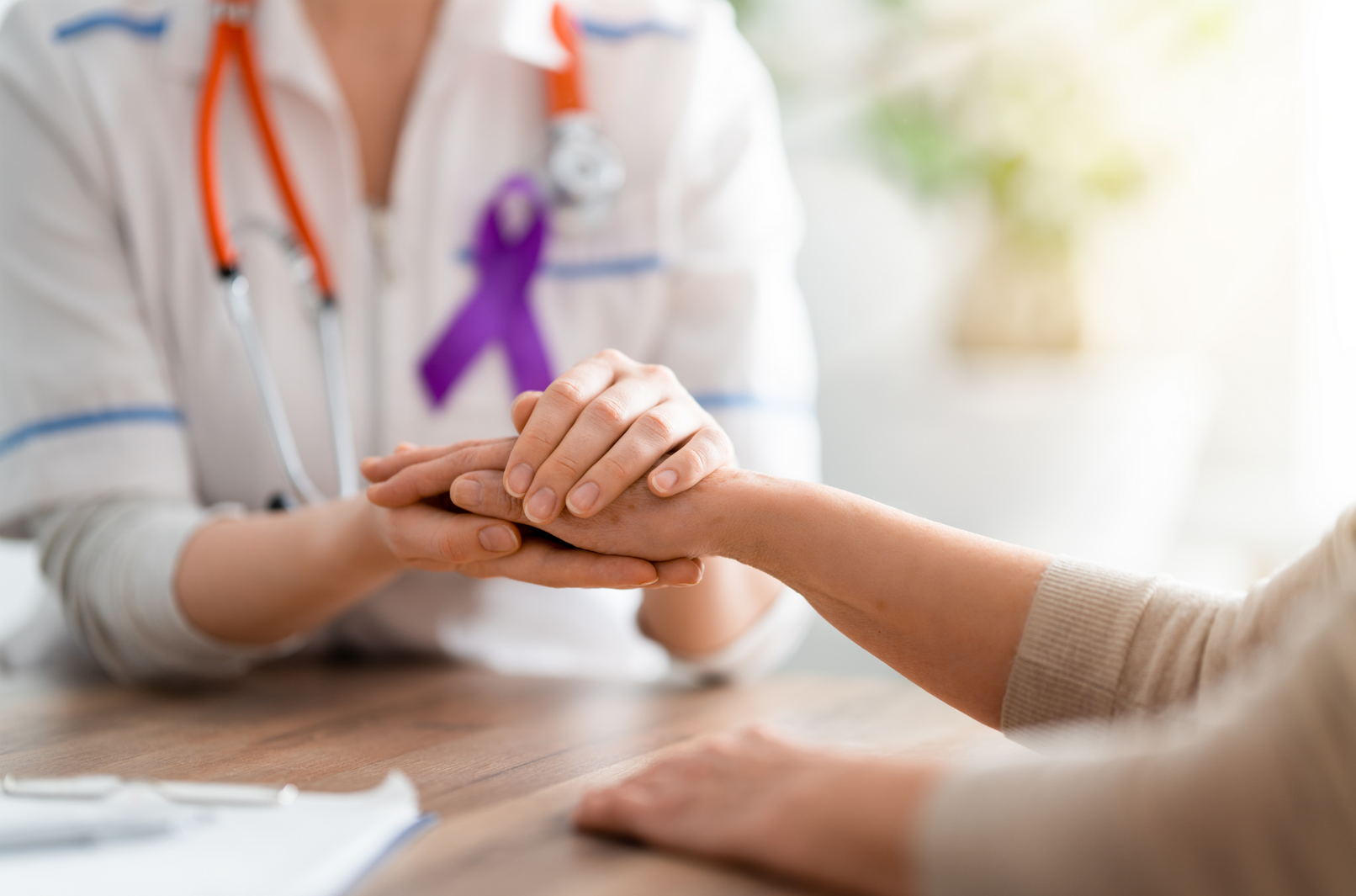 A cancer nurse supporting a female cancer patient