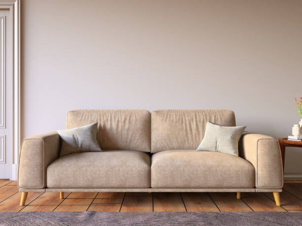 A beige couch positioned in front of a wall, showcasing a neutral office paint color scheme.