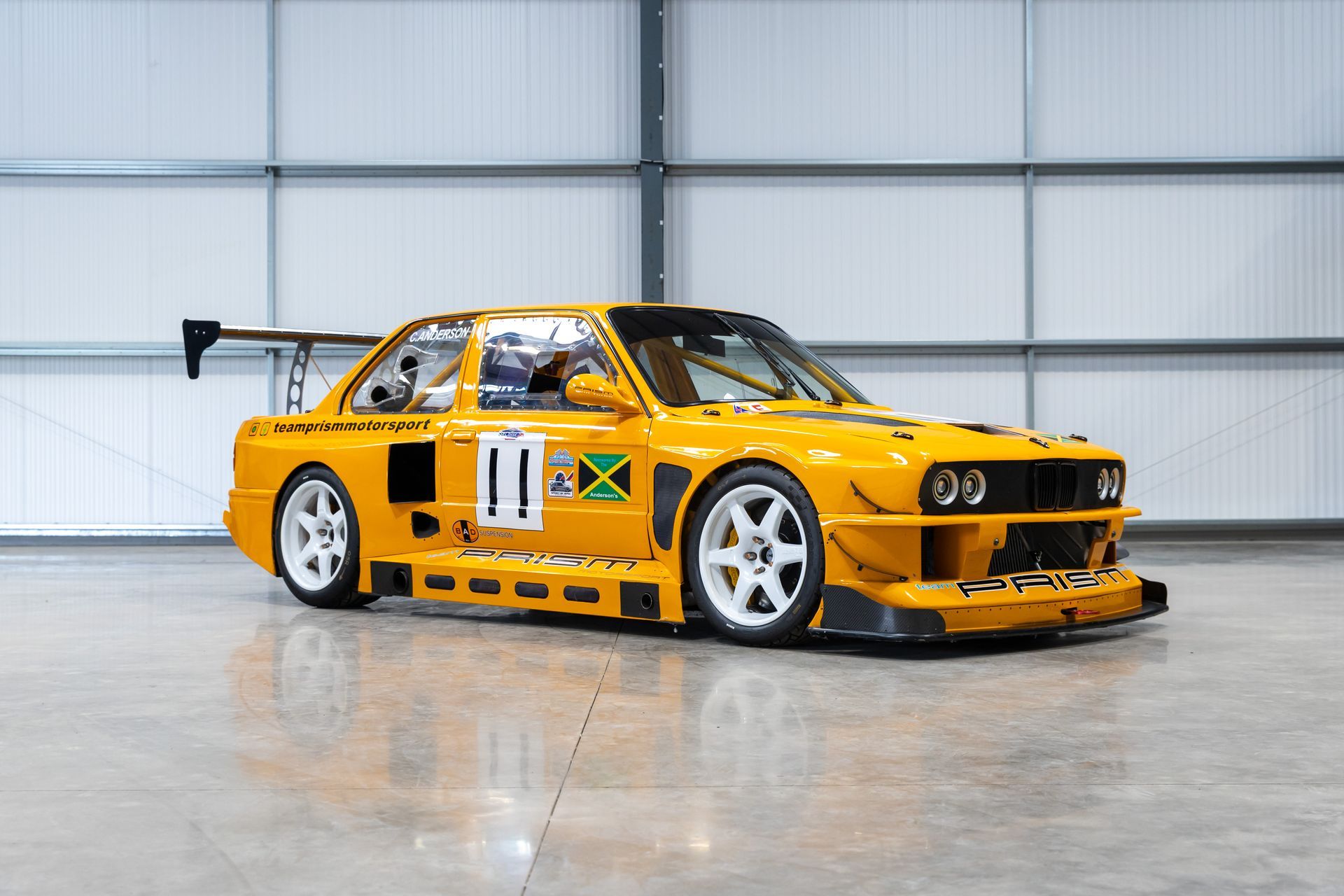 BMW E30 twin-turbo race car in burnt yellow