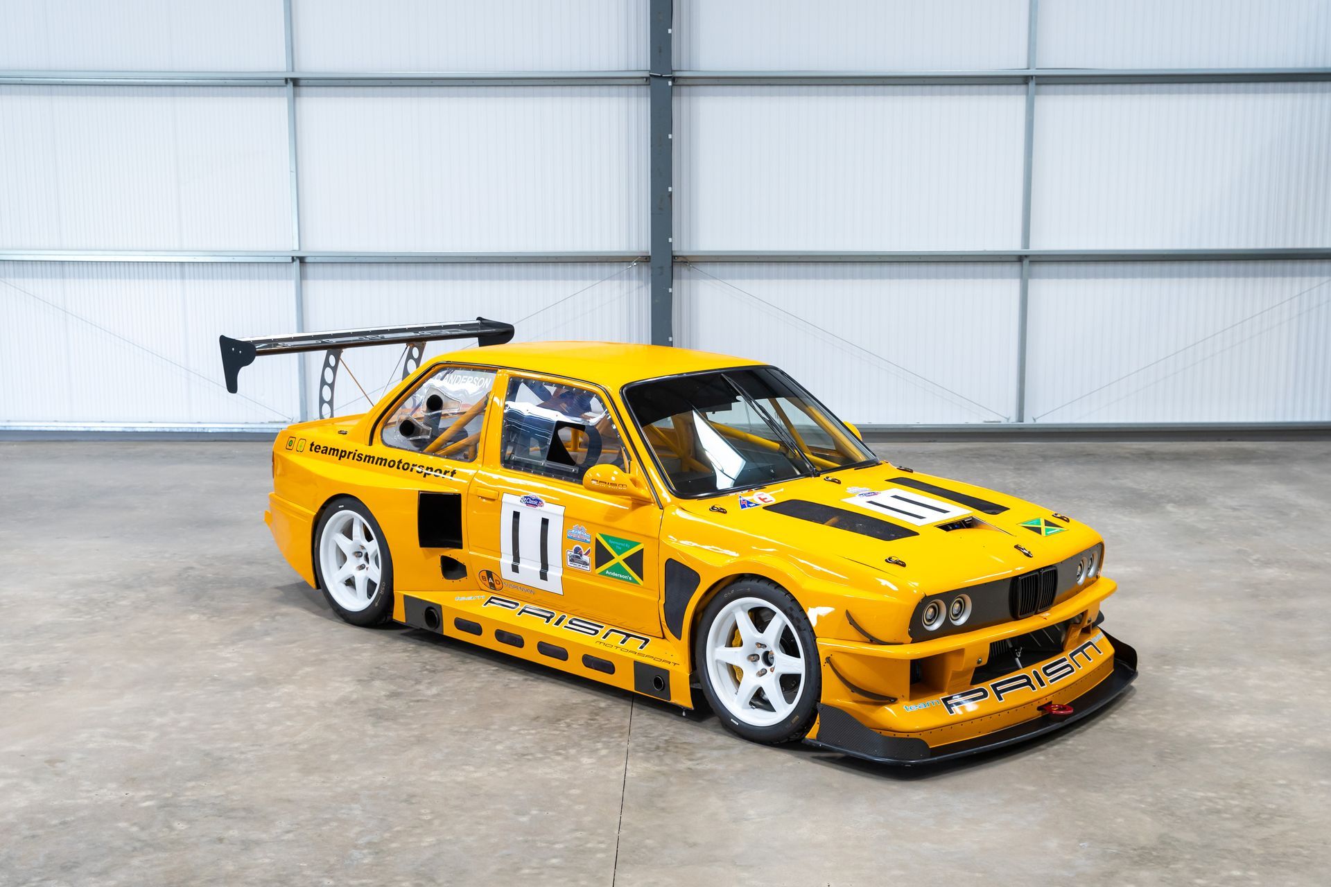 BMW E30 twin-turbo race car in burnt yellow