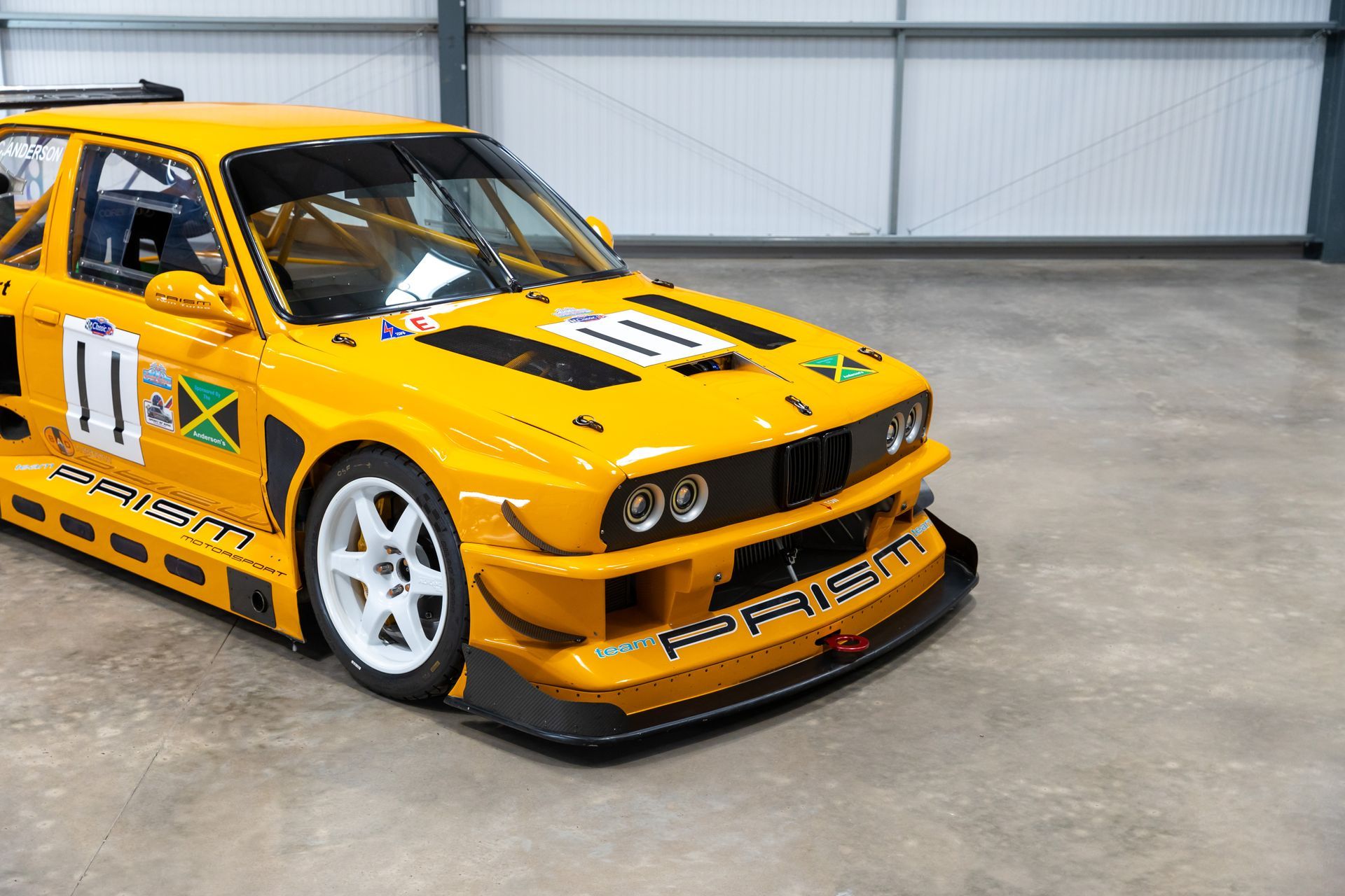 BMW E30 twin-turbo race car in burnt yellow