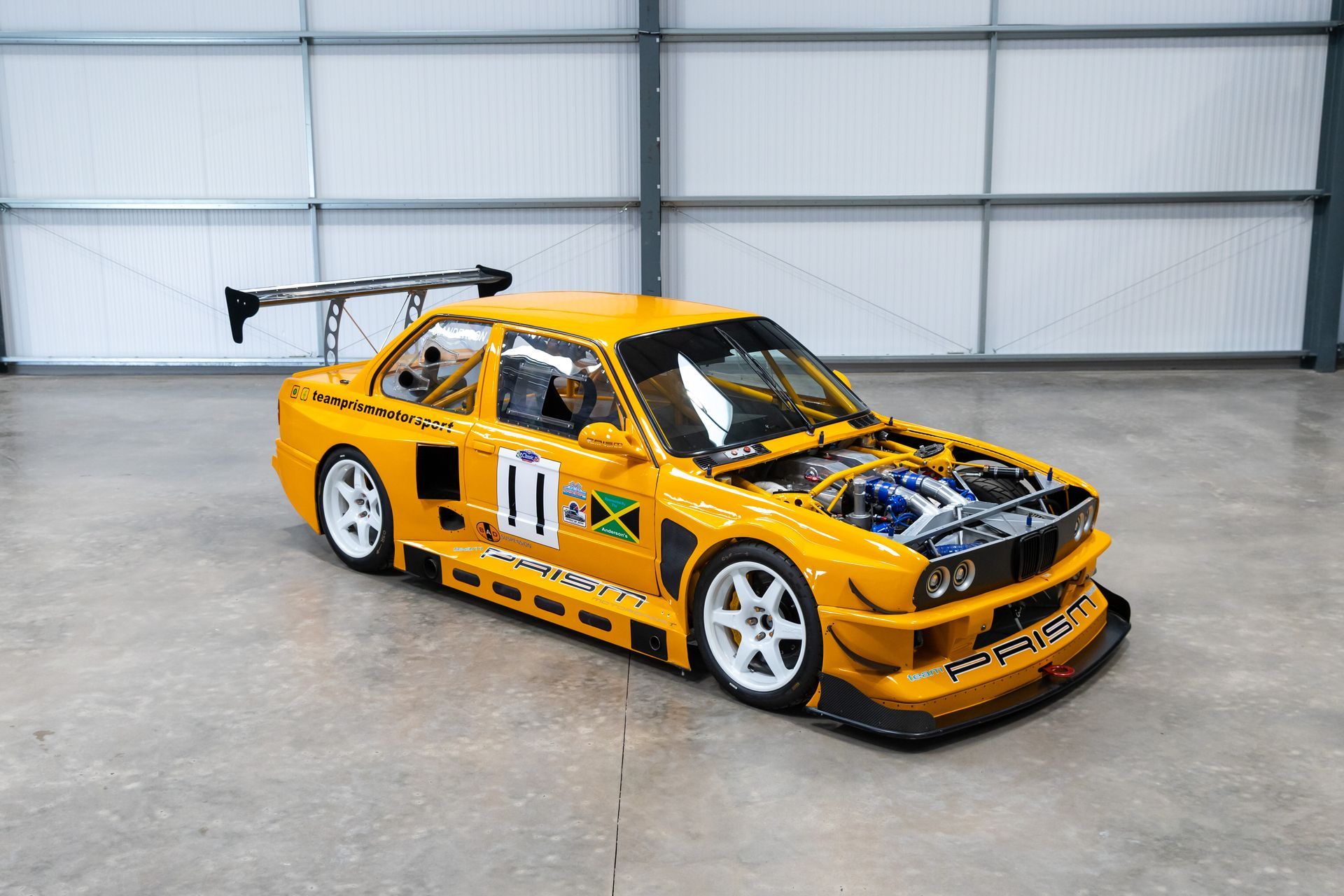 BMW E30 twin-turbo race car in burnt yellow