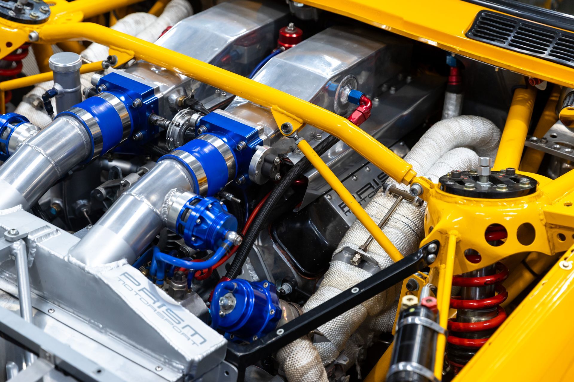 BMW E30 twin-turbo race car in burnt yellow
