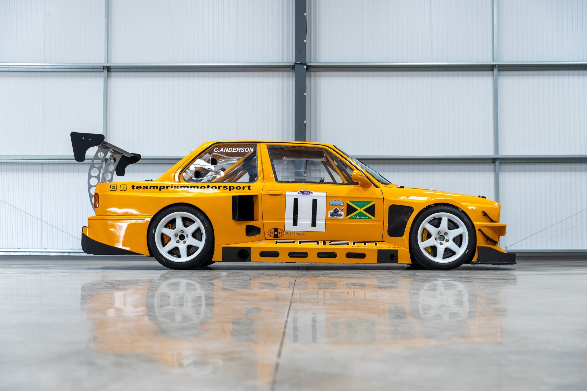 BMW E30 twin-turbo race car in burnt yellow
