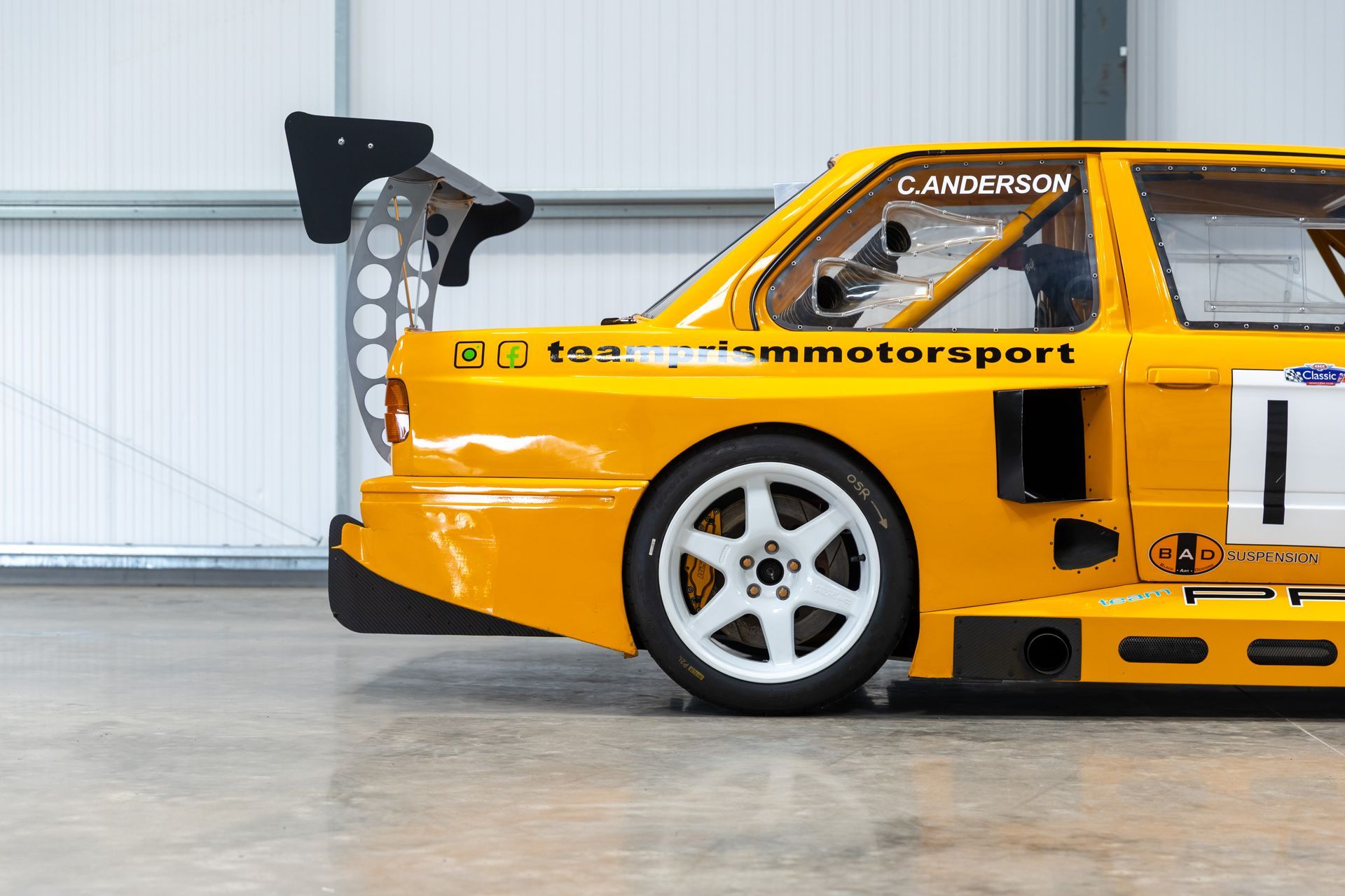 BMW E30 twin-turbo race car in burnt yellow