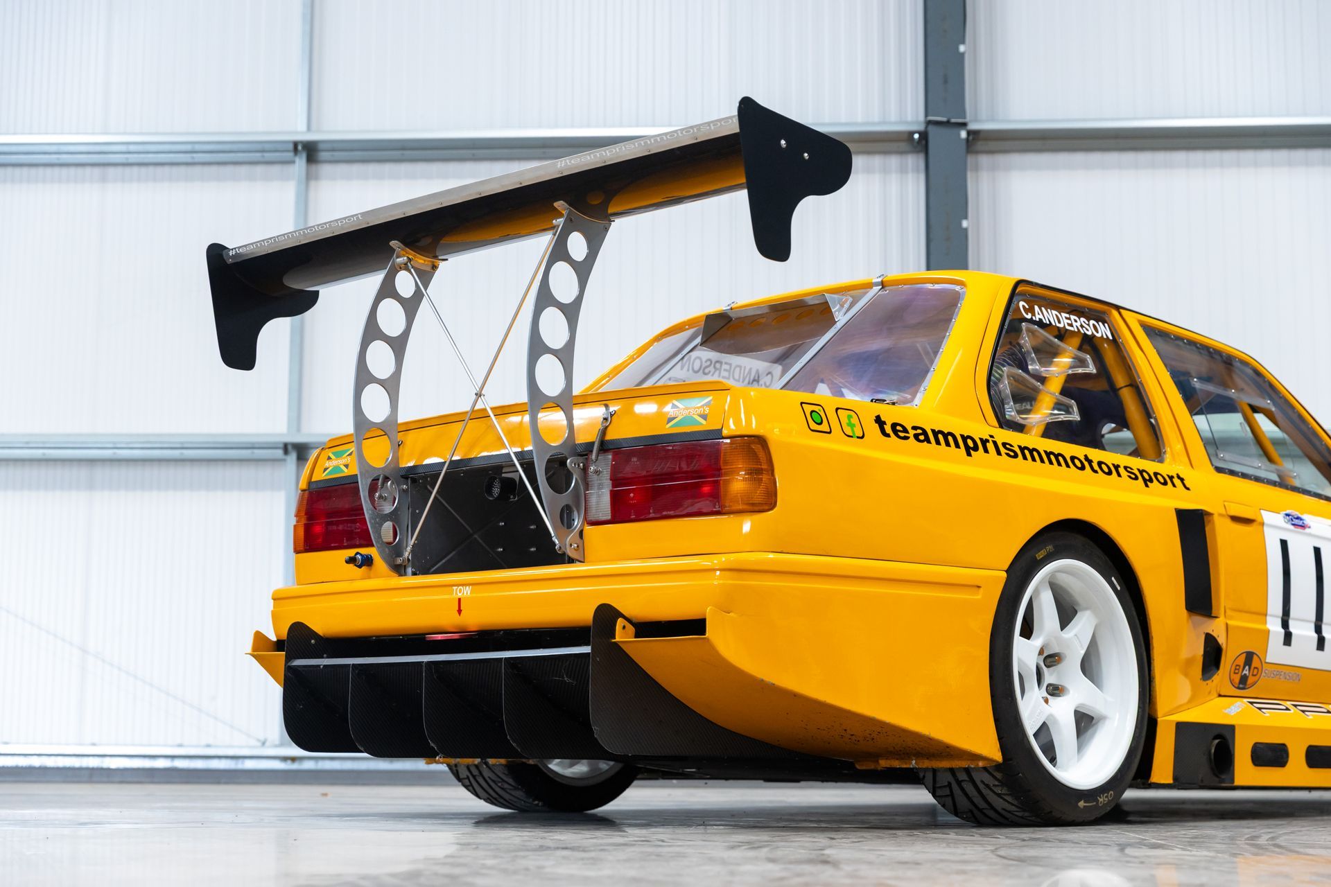 BMW E30 twin-turbo race car in burnt yellow