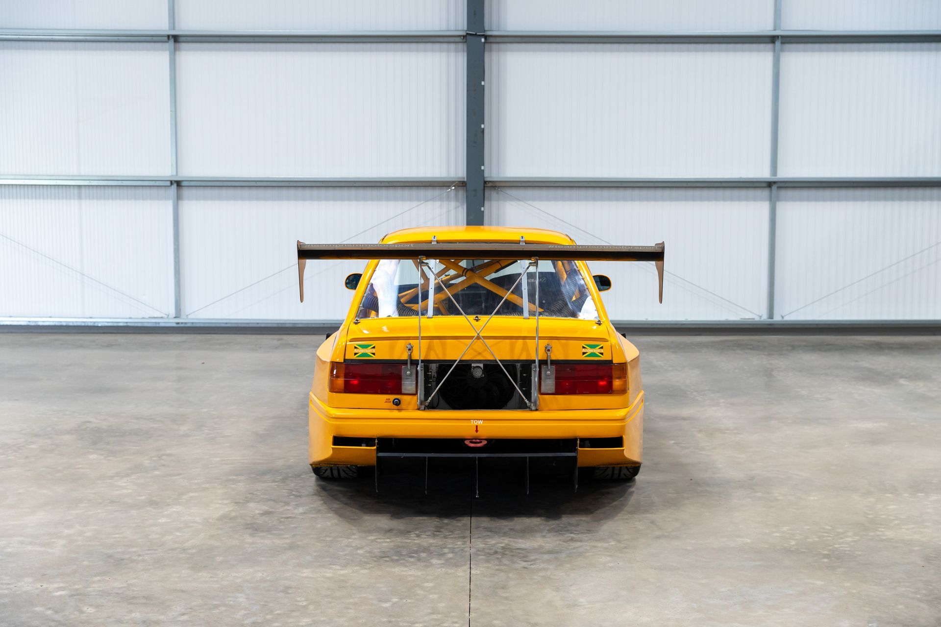 BMW E30 twin-turbo race car in burnt yellow