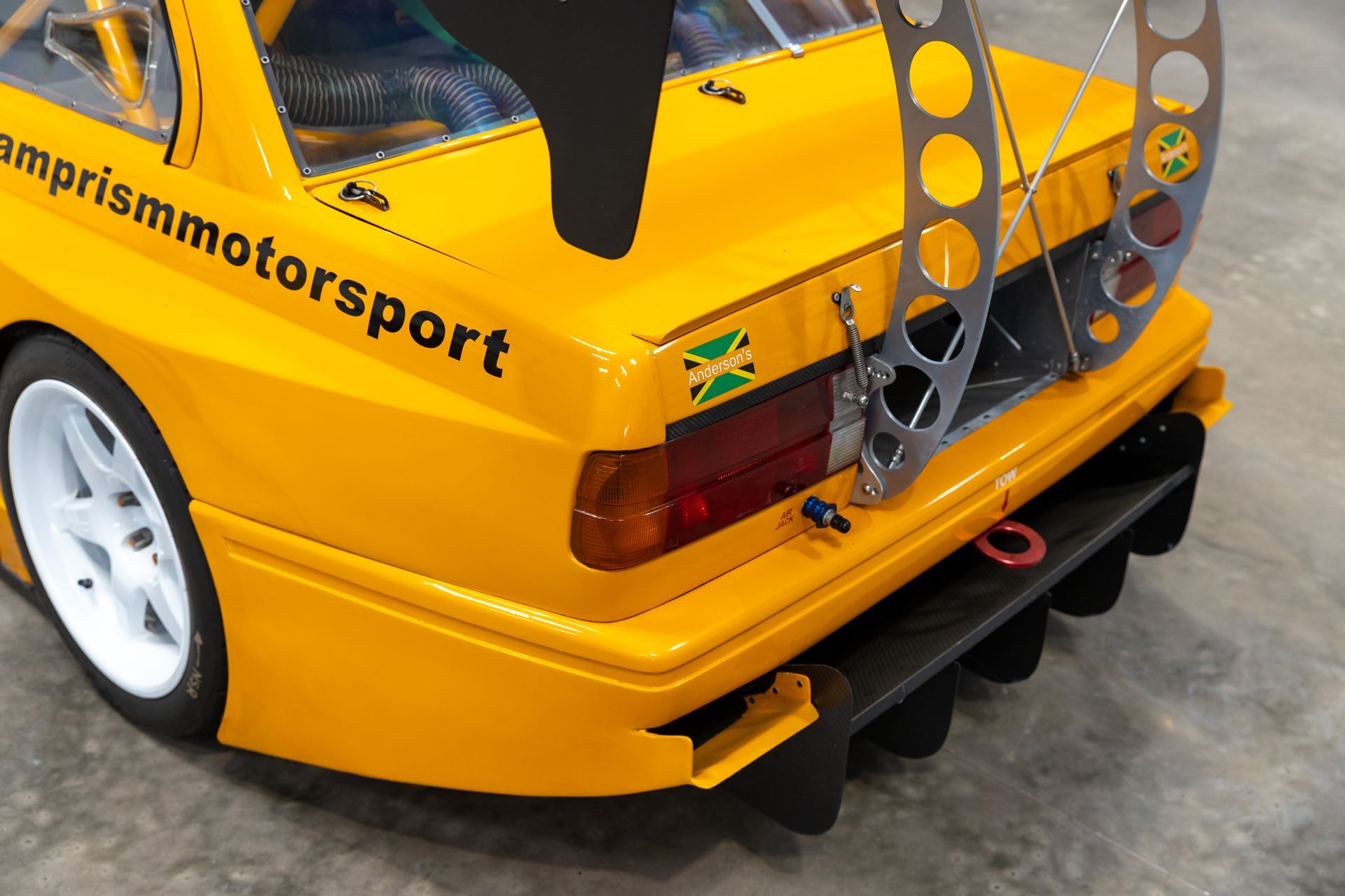 BMW E30 twin-turbo race car in burnt yellow