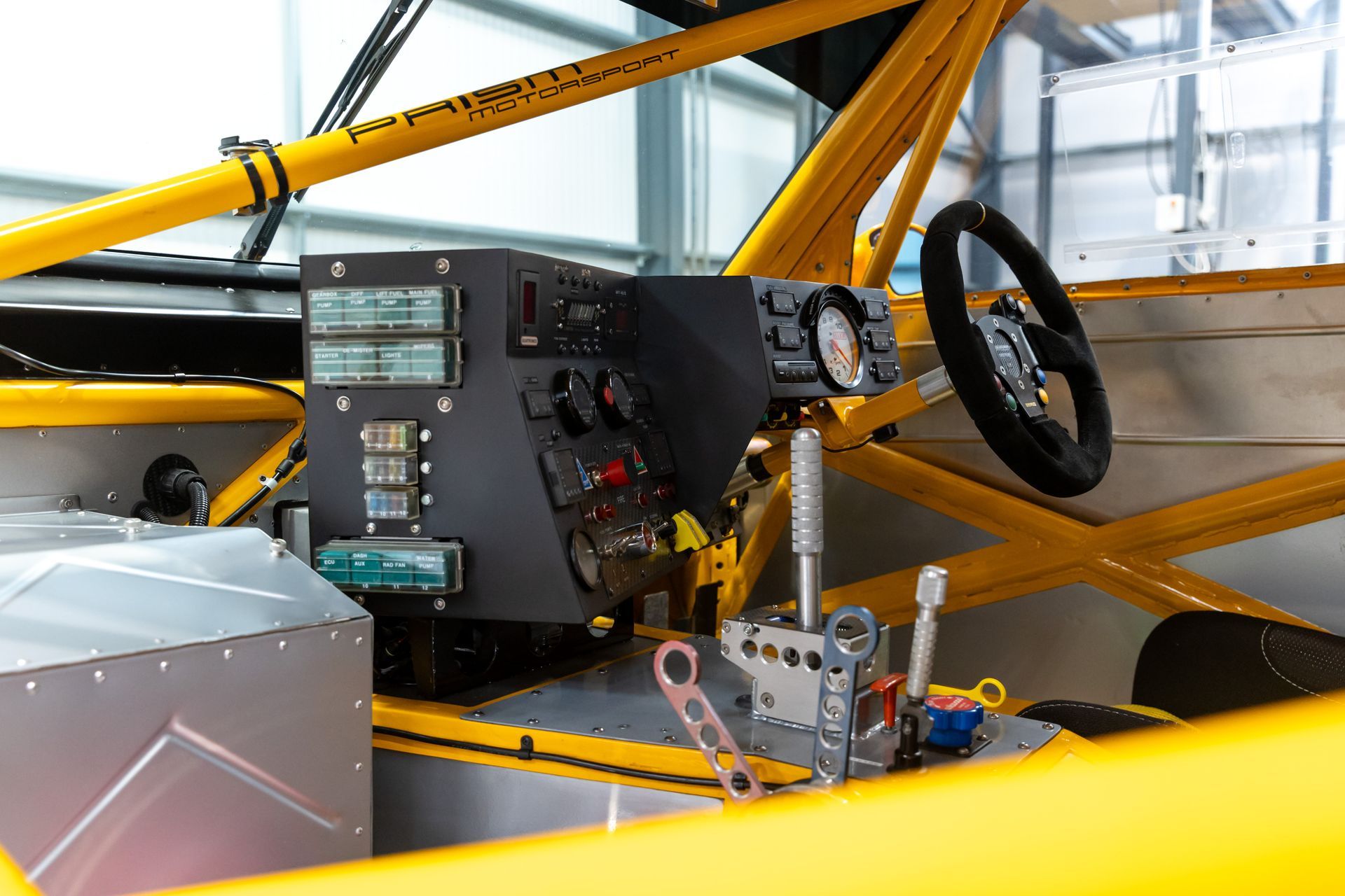 BMW E30 twin-turbo race car in burnt yellow