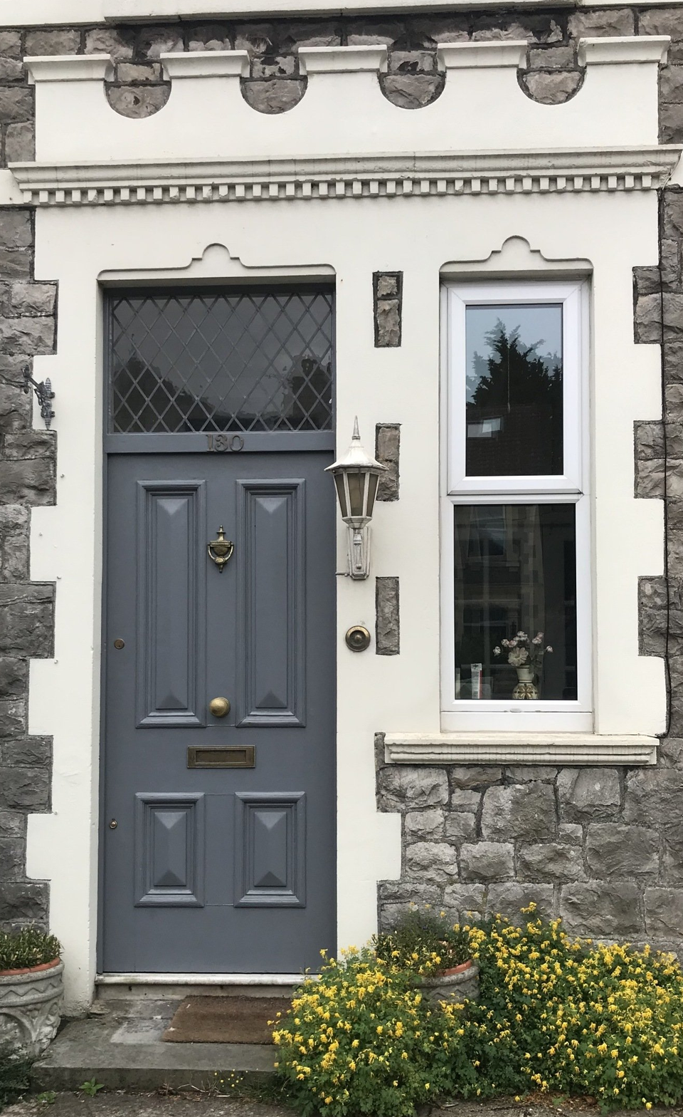 to improve this homes kerb appeal, i would change the lamp and refresh the pots Pimping your front door