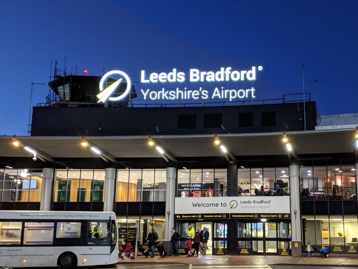 leeds bradford airport terminal building a white bus is just picking up passengers