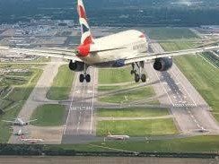 a british airways jet about to touch down on the runway at gatwick airport