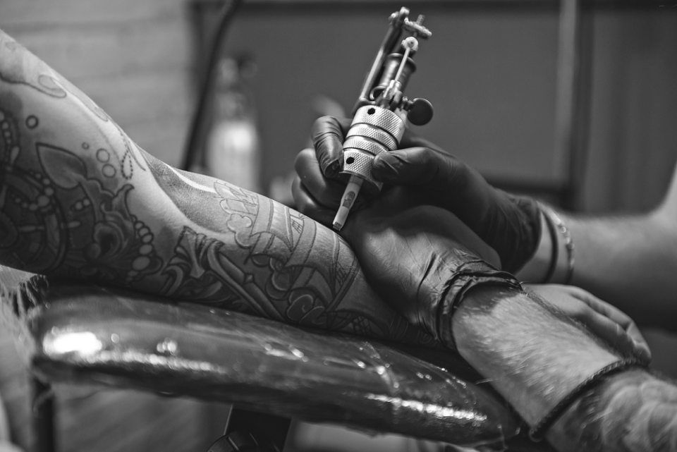 man with a tattoo gun