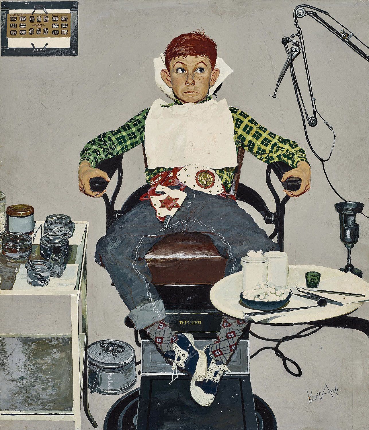 Anxious boy in cowboy outfit sitting in old style dentist chair