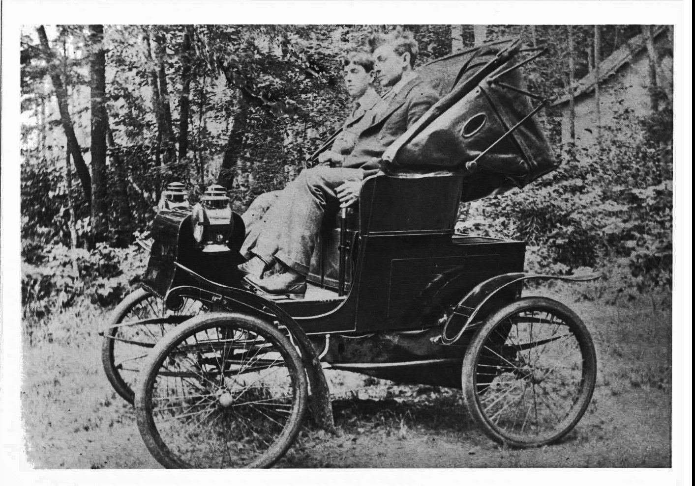two men in a 1909 car