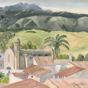 Adobe Church, title rooftops, a palm tree with mountains in the background