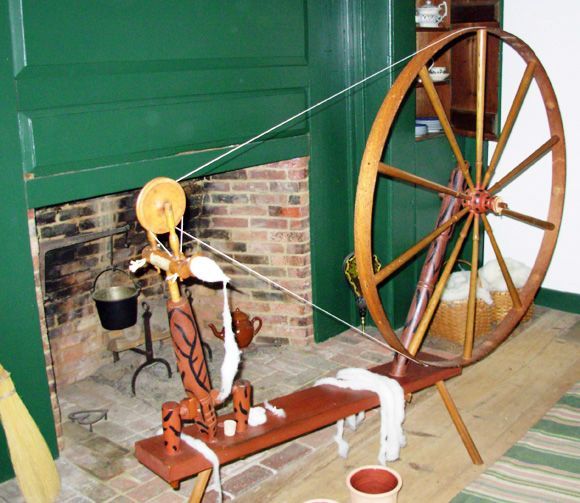Walking wheel with yarn draped over base