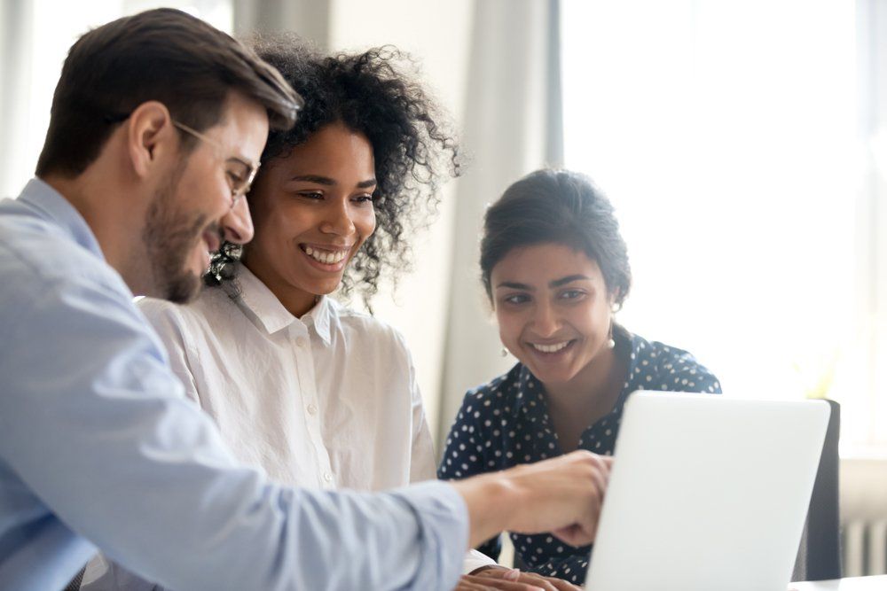 a group of people looking at a computer screen