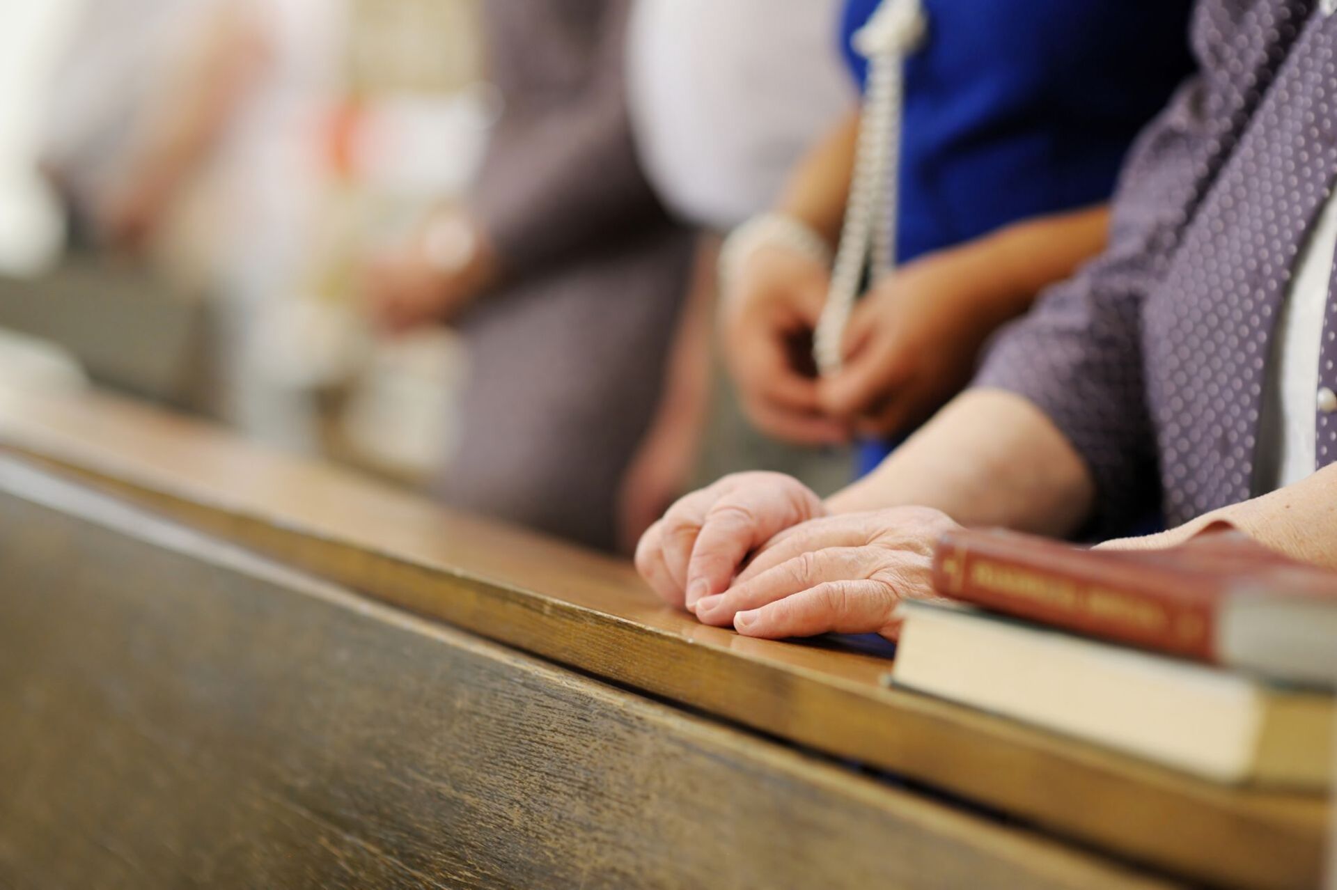 image of people standing at church pews