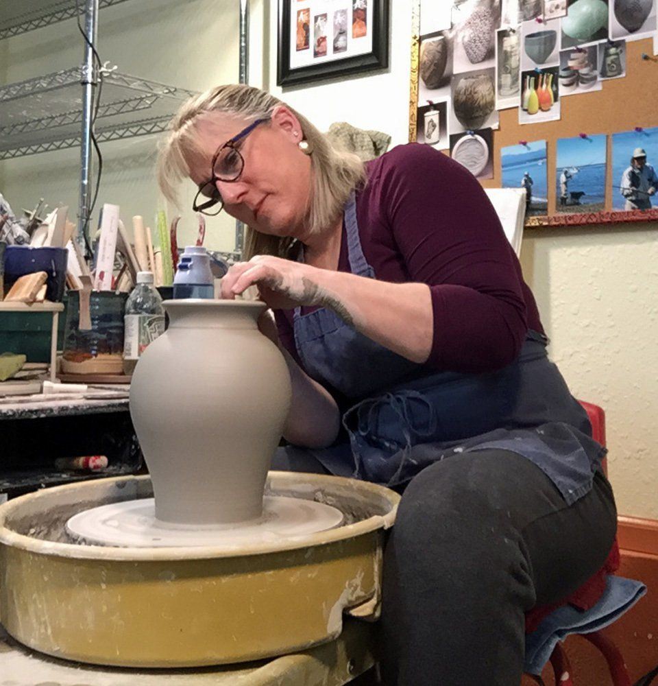 Throwing a vase, defining the lip.