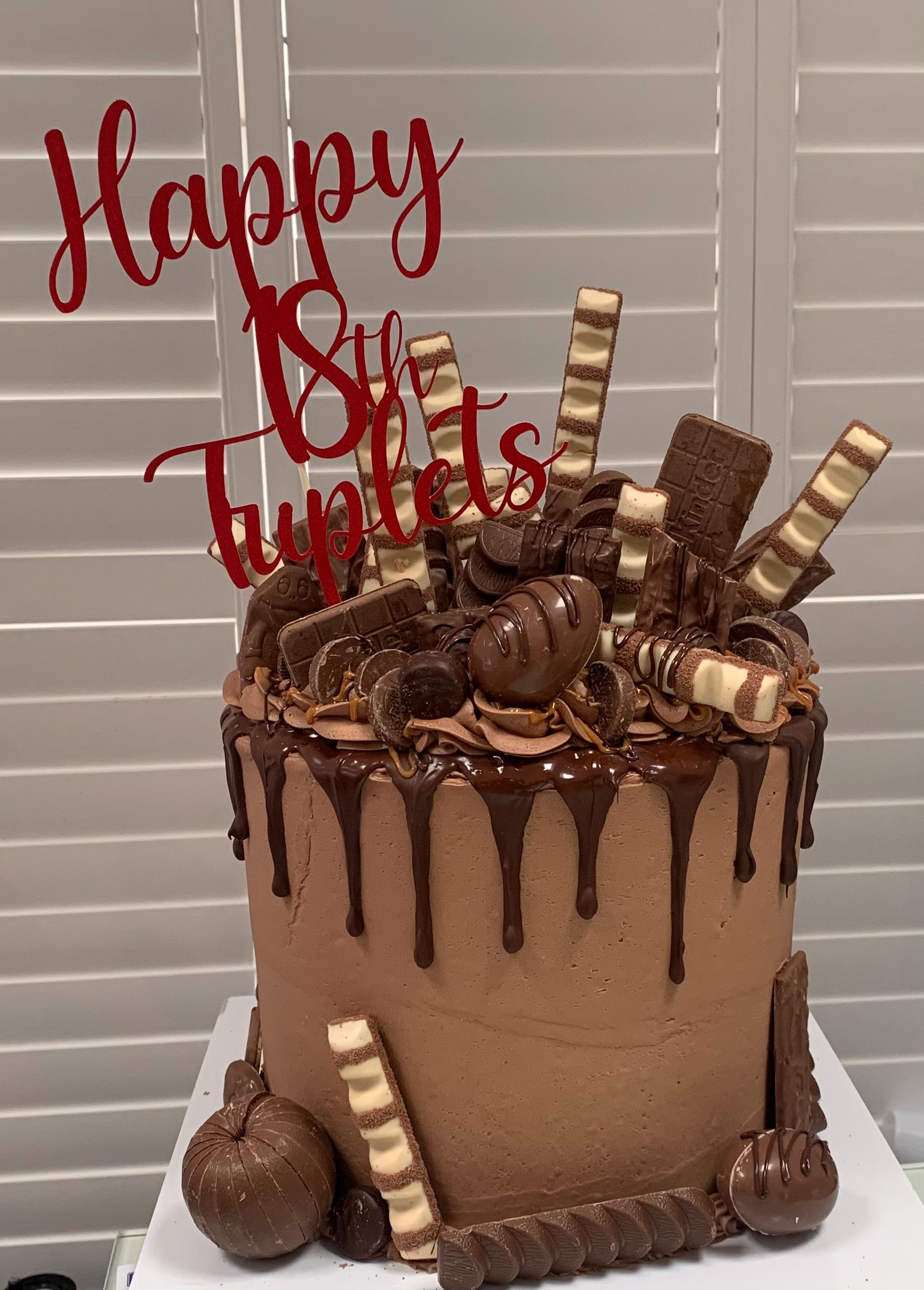 Vanilla Cake  with chocolate frosting & topped with chocolate bars