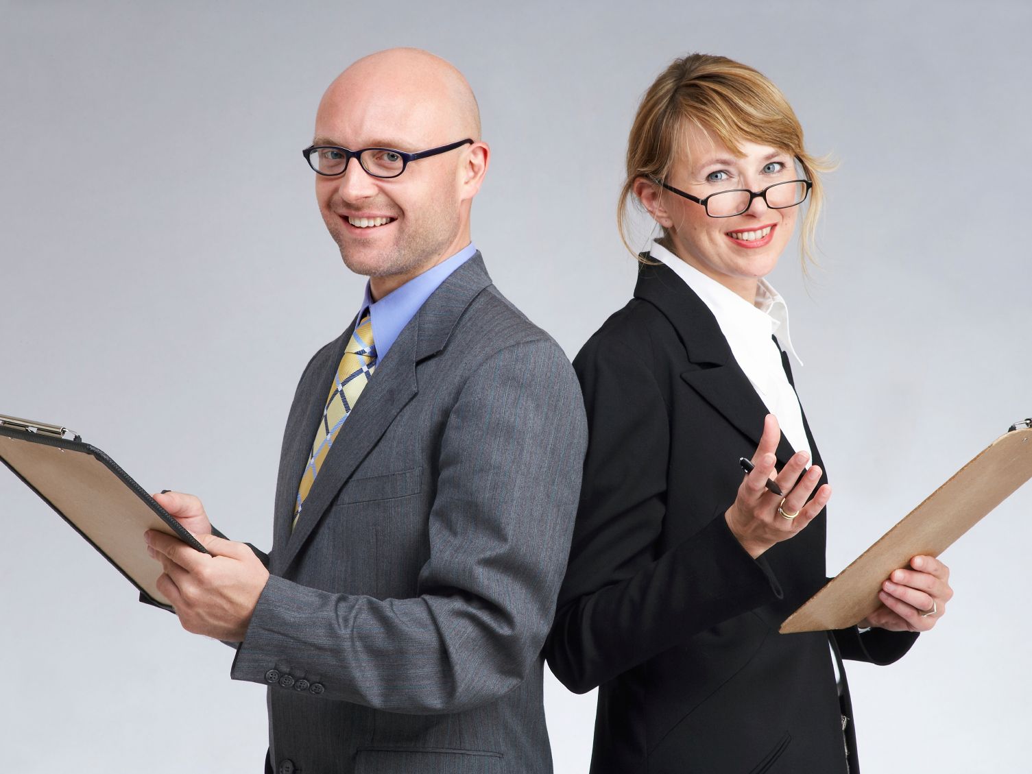 Two surveyors holding clipboards