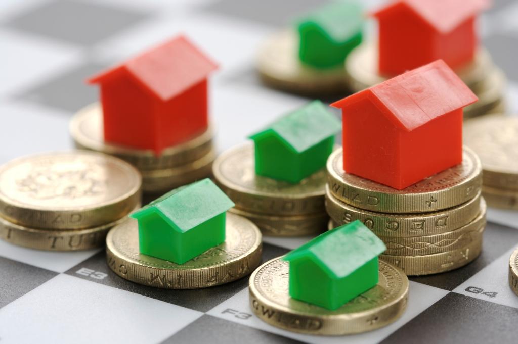 Model houses on coins representing a property valuation
