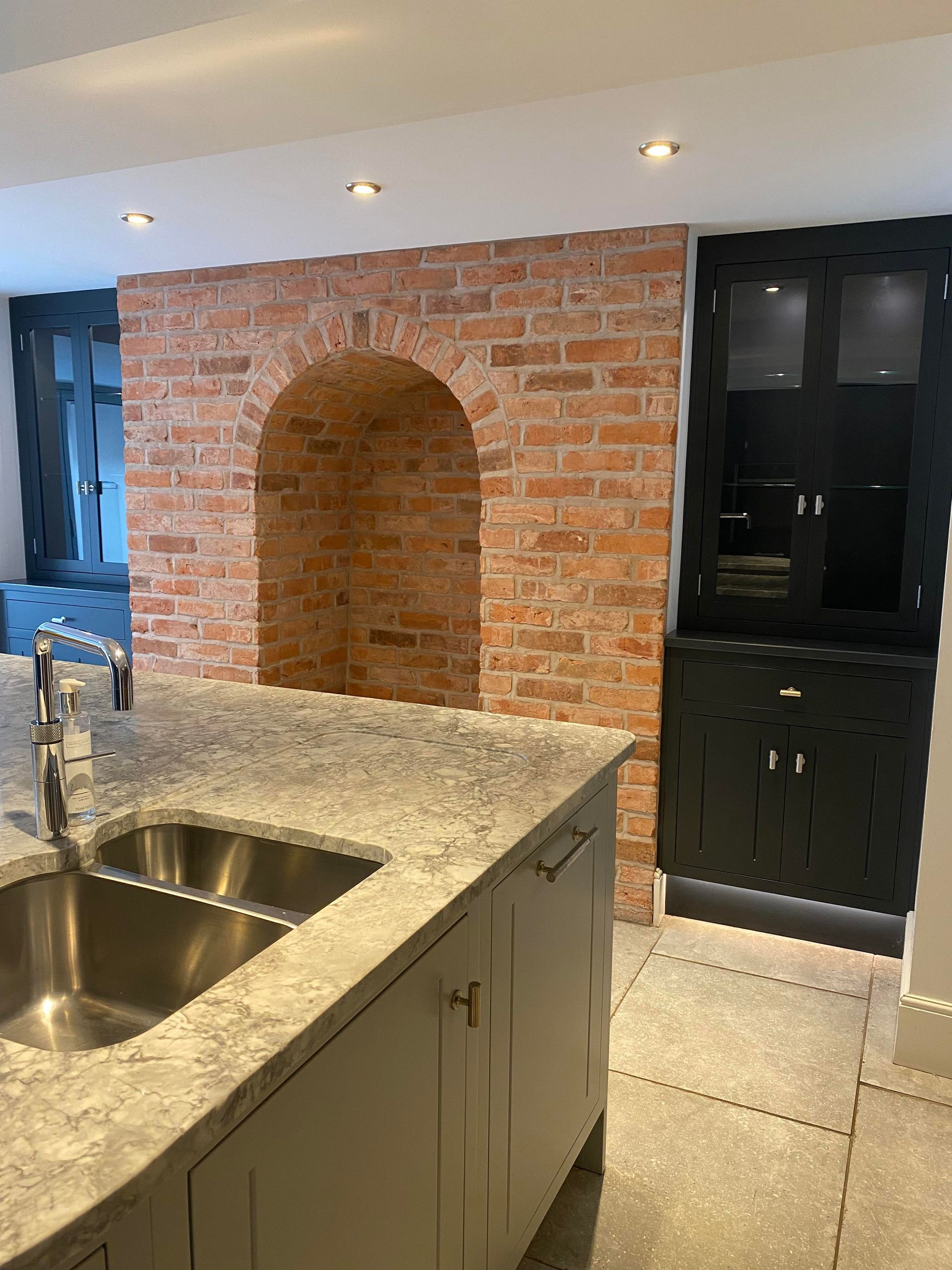 Professional kitchen clean featuring granite worktops, stainless steel sink, and exposed brickwork – Whitchurch, Shropshire