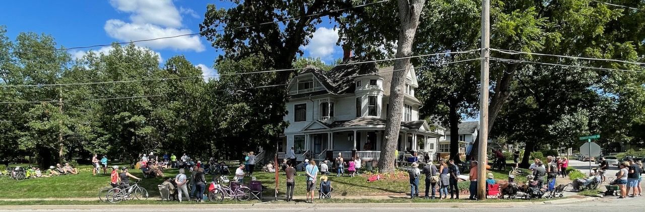 A large crowd listens to Sarah Routh at PorchFest DSM 2022