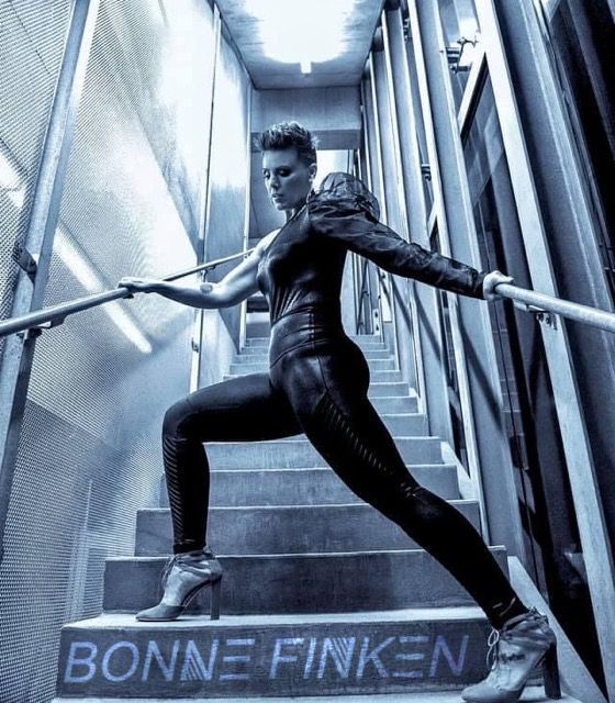 Photo of Bonne Finken striking a powerful pose on stairs