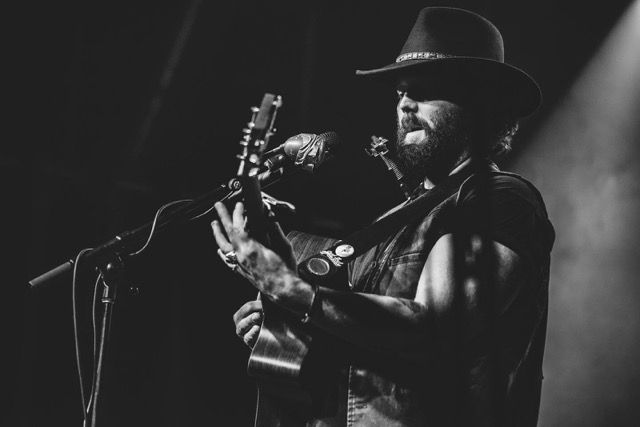 Photo of Luke Fox playing on a dramatically lit stage
