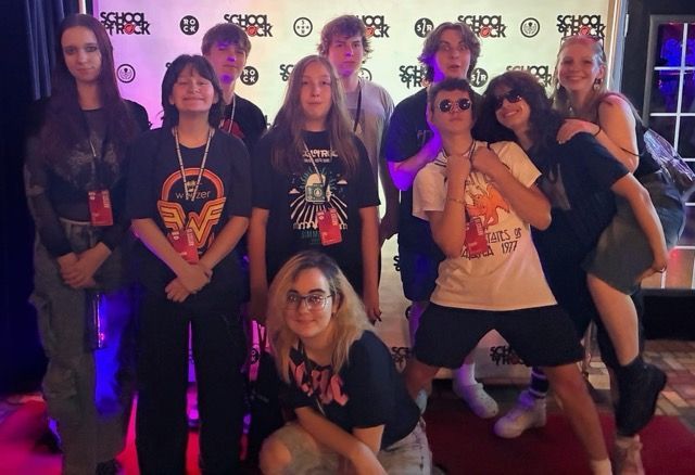 The School of Rock's house band is serious about having a fun performance!