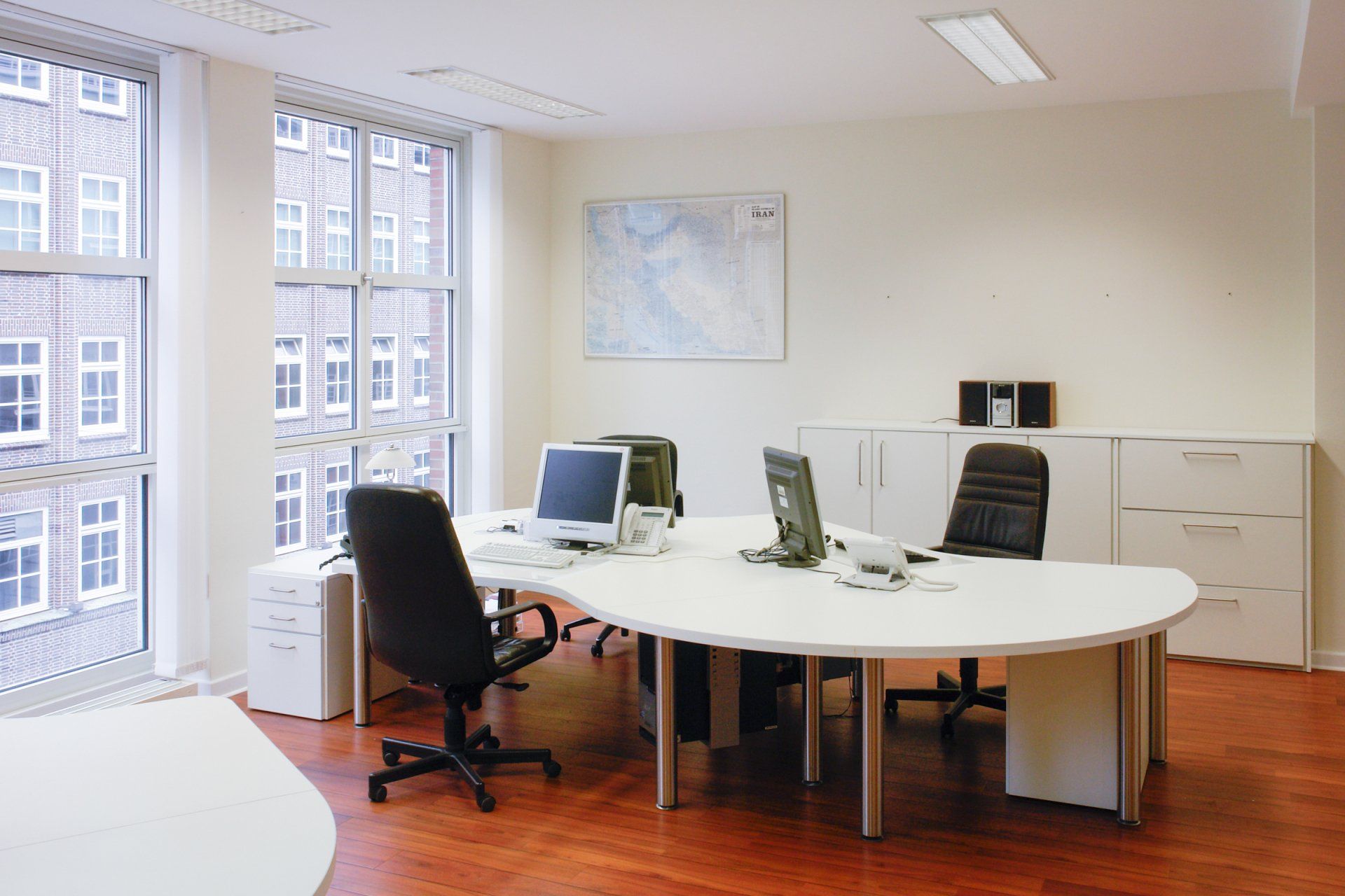 Arbeitsplatz mit Tisch und Schrank von ip20 Büroeinrichtung