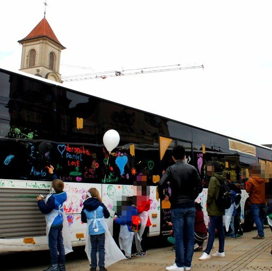 Kinder bemalen einen Bus beim Kinderfest in Ludwigsburg