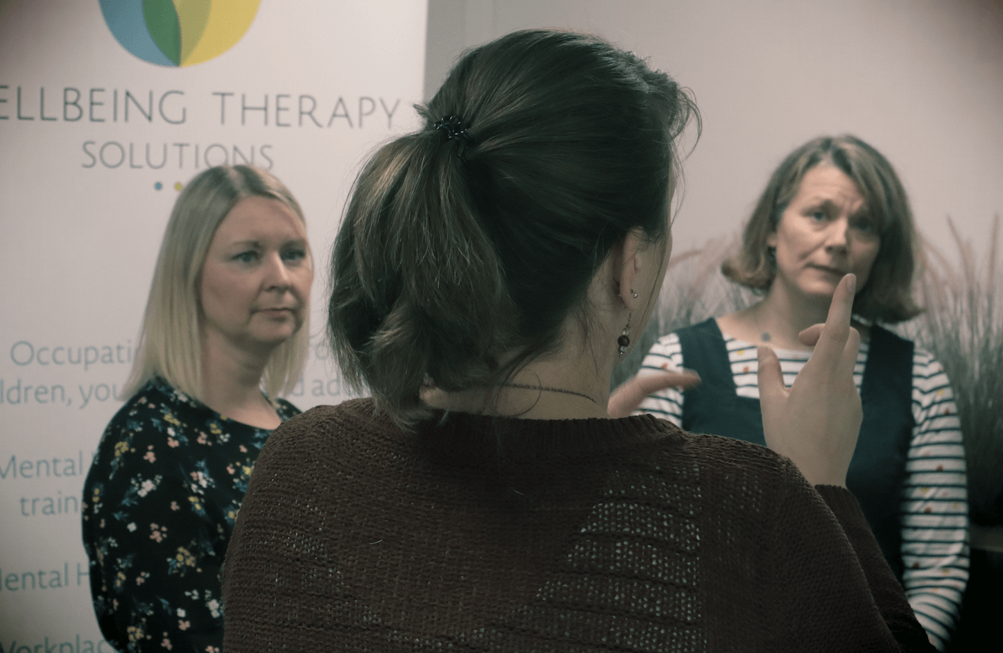 Therapist Marjolein Cleaver speaks to her colleagues in a training room