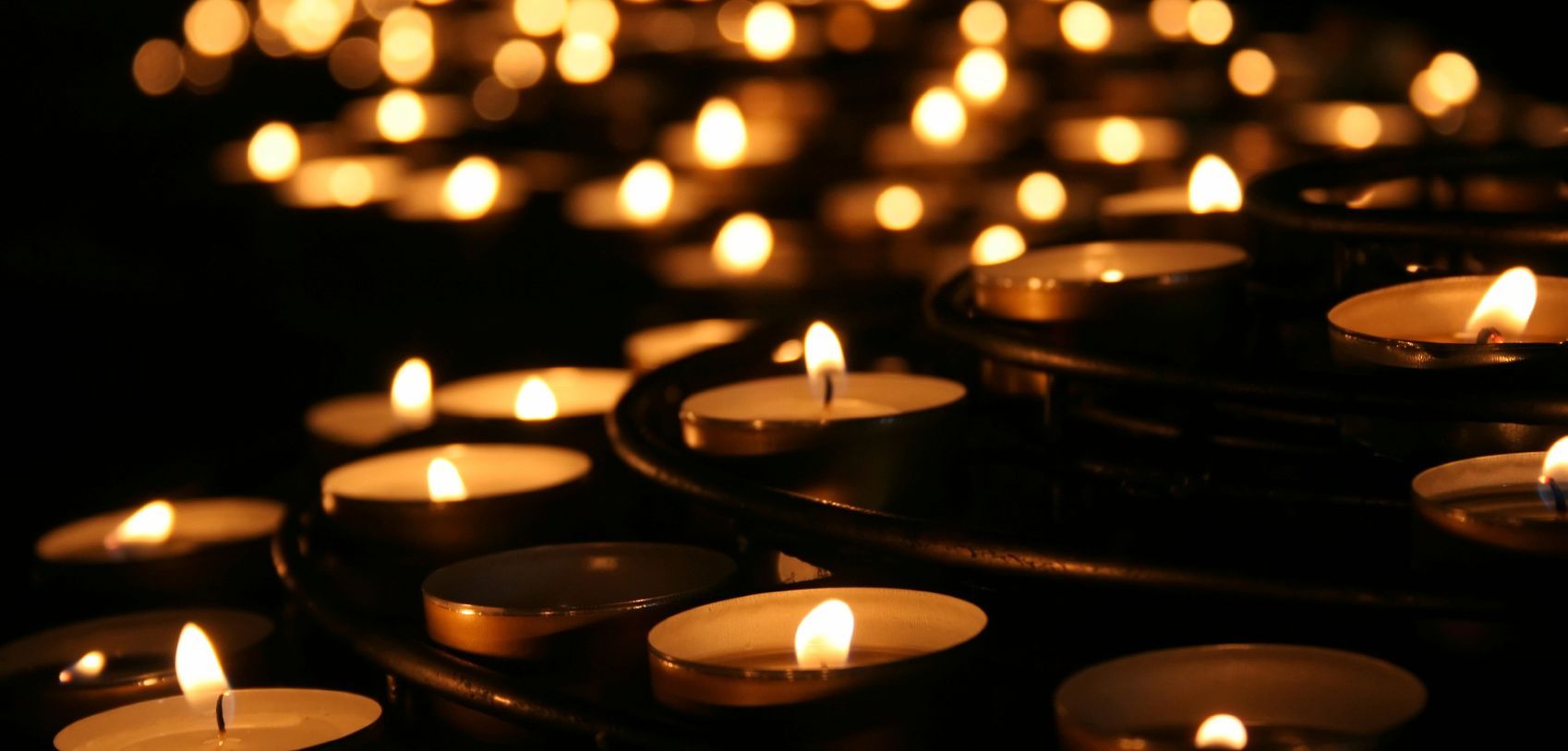 Lots of candles burning in the dark