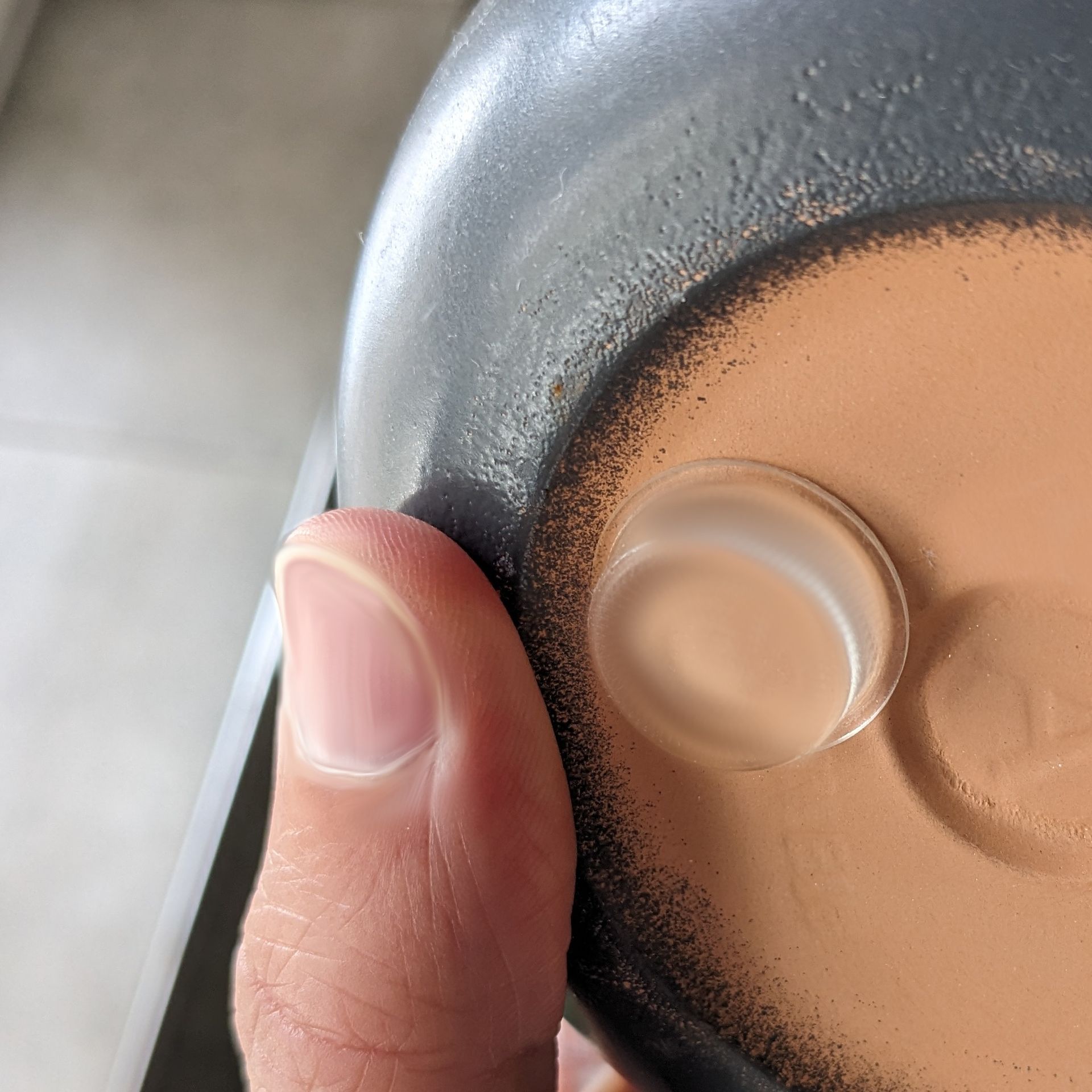 A clear rubber foot used on the base of a ceramic plant pot