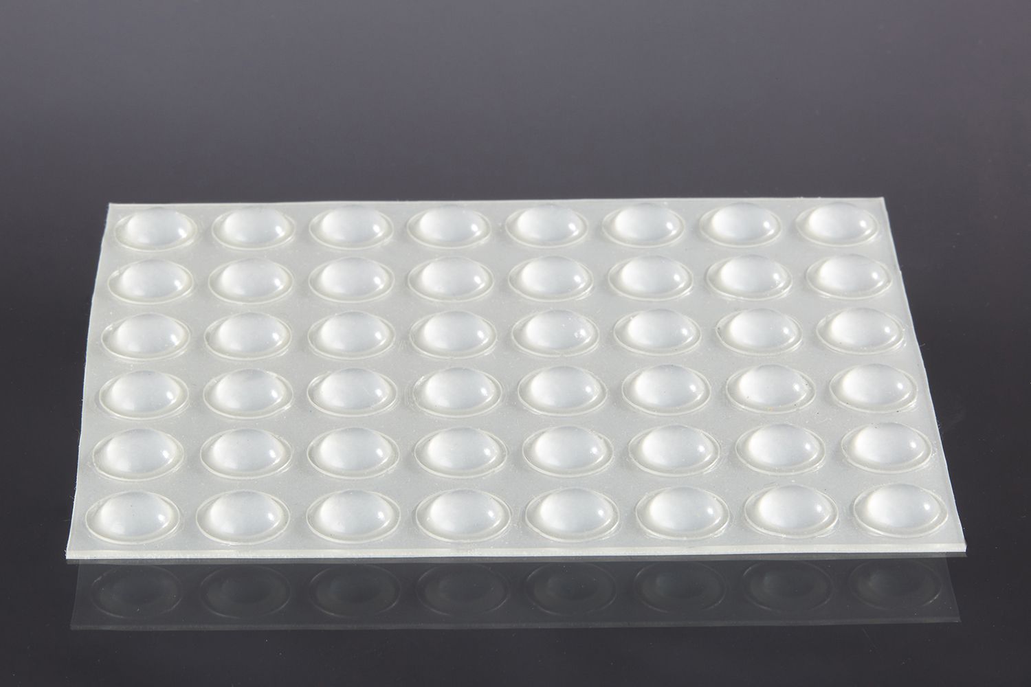 a sheet of domed rubber feet.