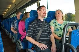 Passengers relaxing comfortably inside a spacious Hudson Valley Legacy charter bus for a group trip.