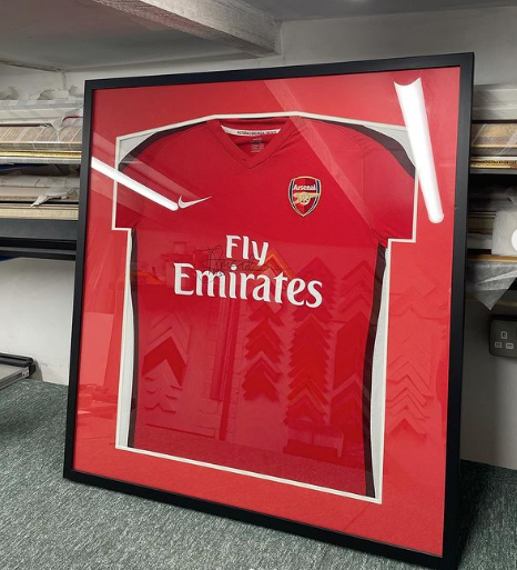 A framed Arsenal Football club football shirt