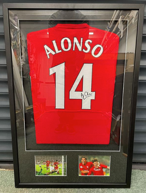 A framed Liverpool football club shirt