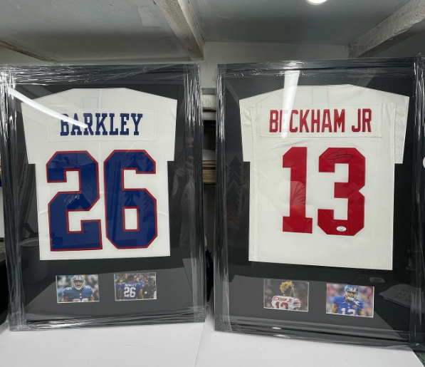 A pair of framed new york giants american football shirts