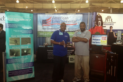 American Environmental CEO and employee in front of display
